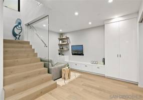 Custom staircase to the bonus room, bedrooms and large laundry room.