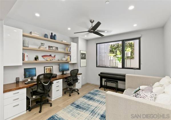 Home office for two can double as a bedroom when the custom doors are folded shut.