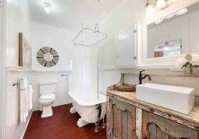 Remodeled bathroom features original bathtub that has been refinished.