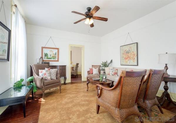 Floor in living room displays a decorative, period linoleum inlay, applied over well-preserved original wood flooring.