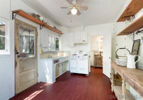 Kitchen features a vintage stove and tile.