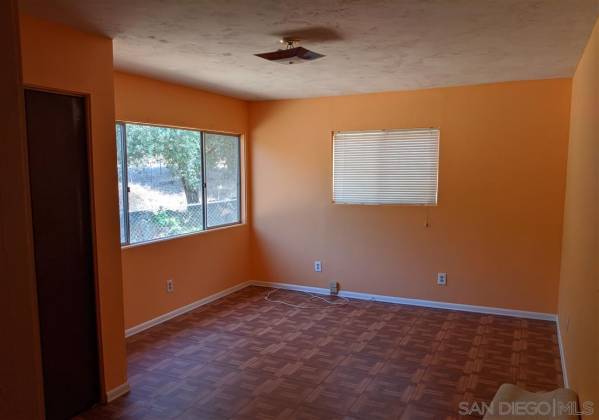 This is one of the bedrooms that was added on. It has vinyl flooring.