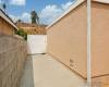 Concrete beside garage through wide fencing.