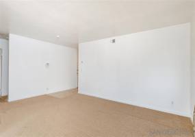 Living room looking toward wall with security alarm.