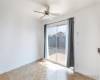 Dining area with ceiling fan by sliding glass door.